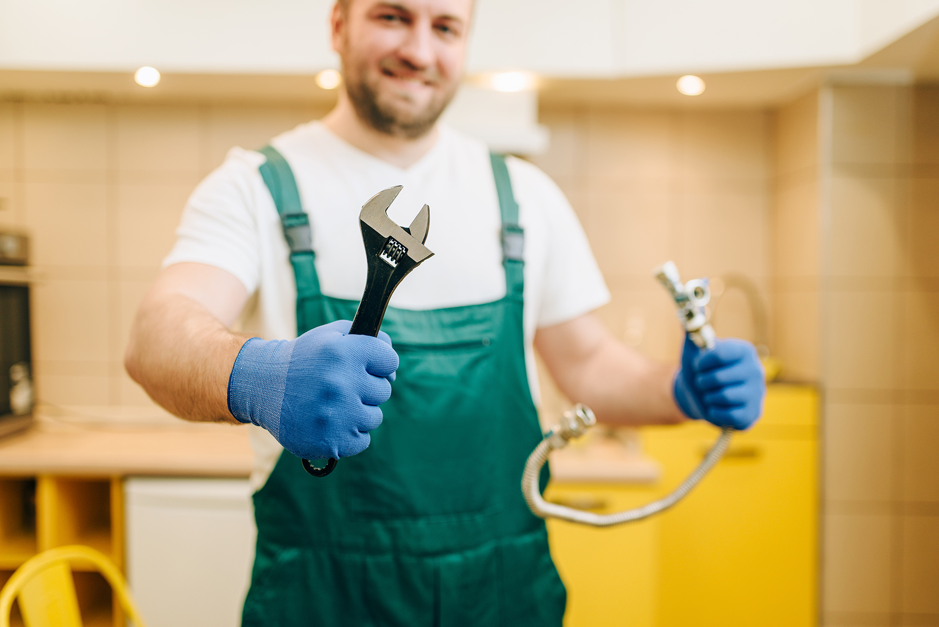 plumber-in-uniform-holds-wrench-handyman-living-quinn-residences